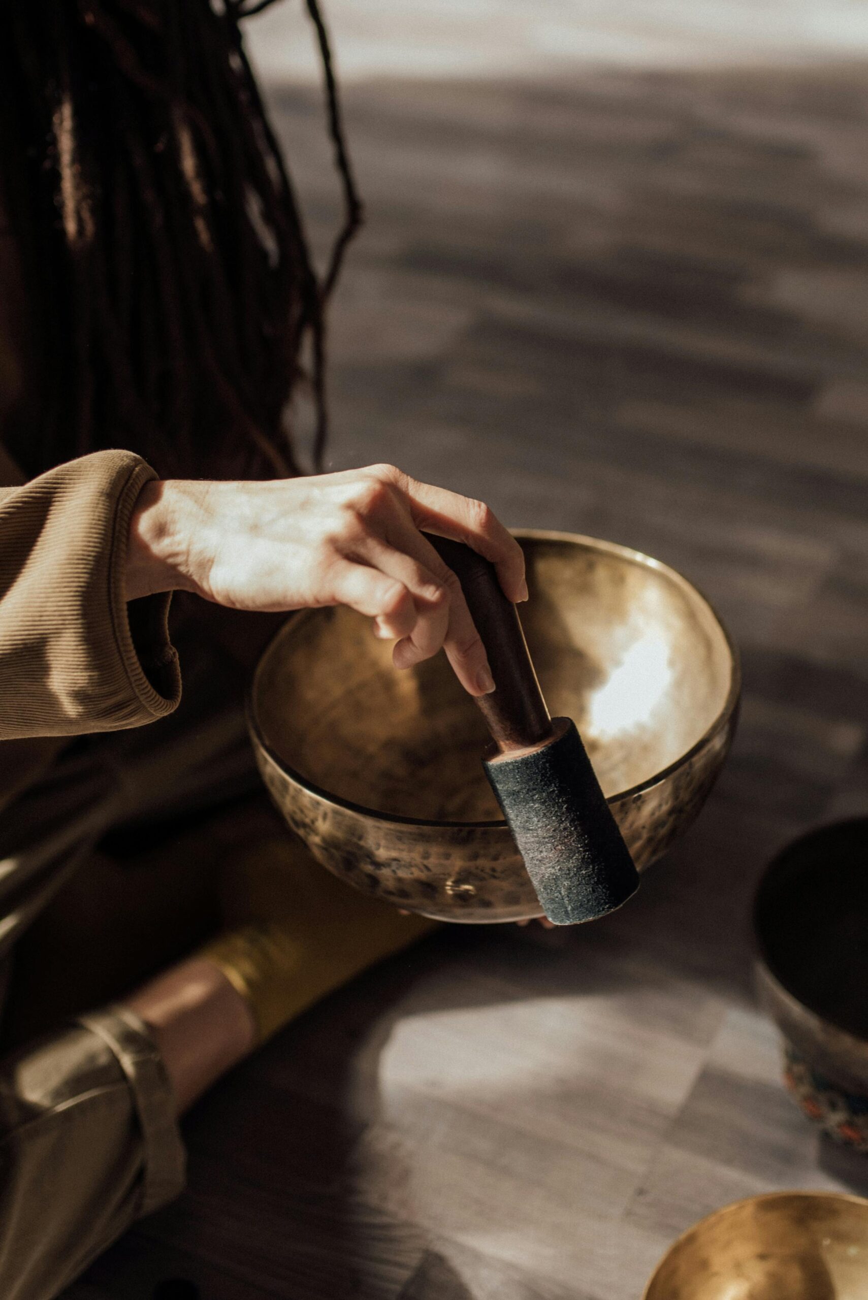 Image of person using a tibetan singing bowl